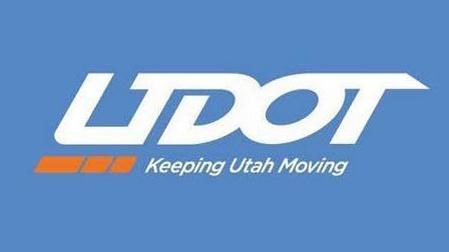 Blue lettering on a white background "UDOT" and "Keeping Utah Moving" underneath with orange line