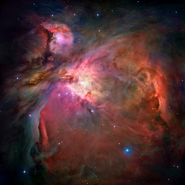 The swirling pink, orange and yellow dust of the Orion Nebula.