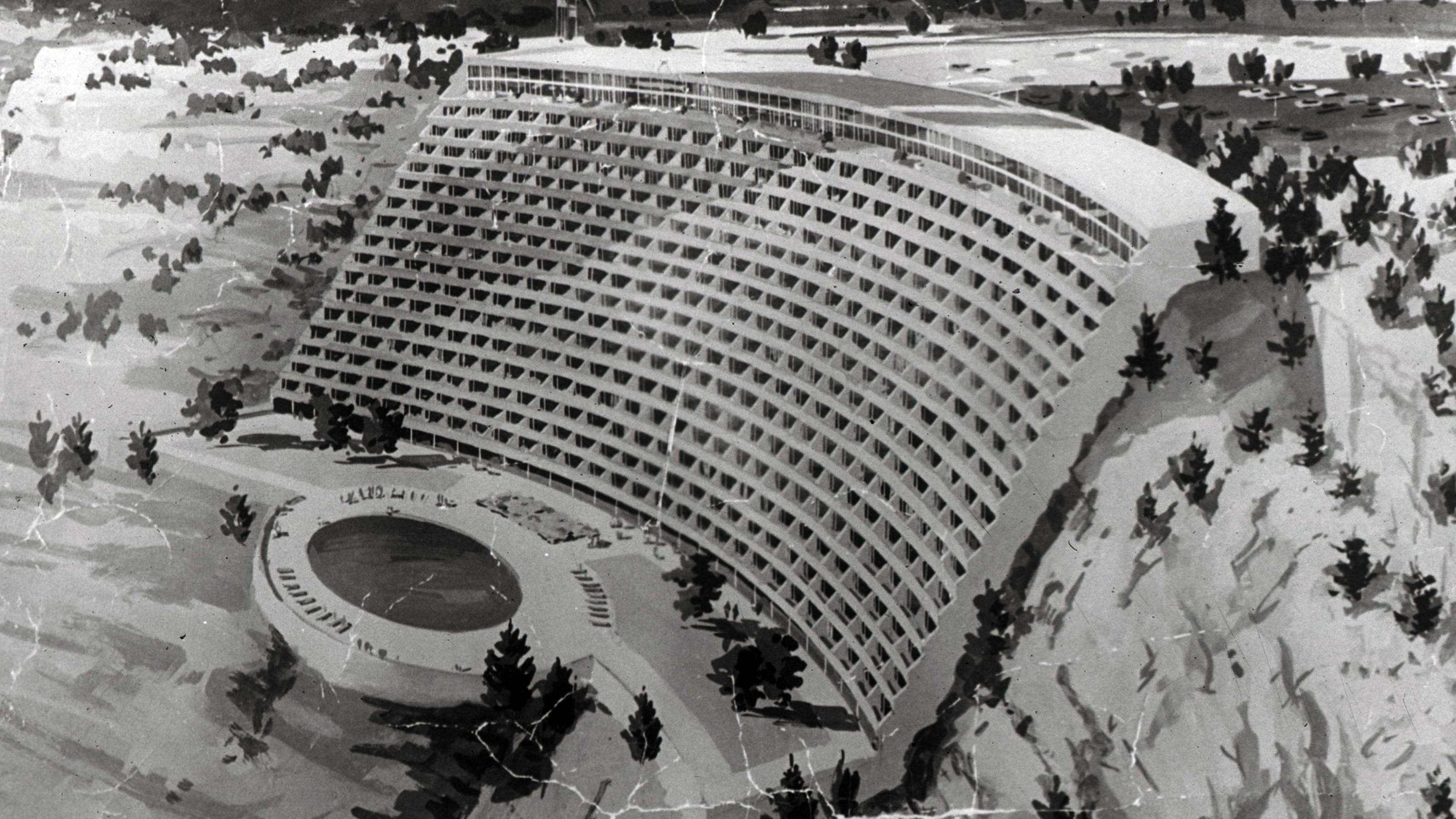 A black and white photo of a hotel on the rim.