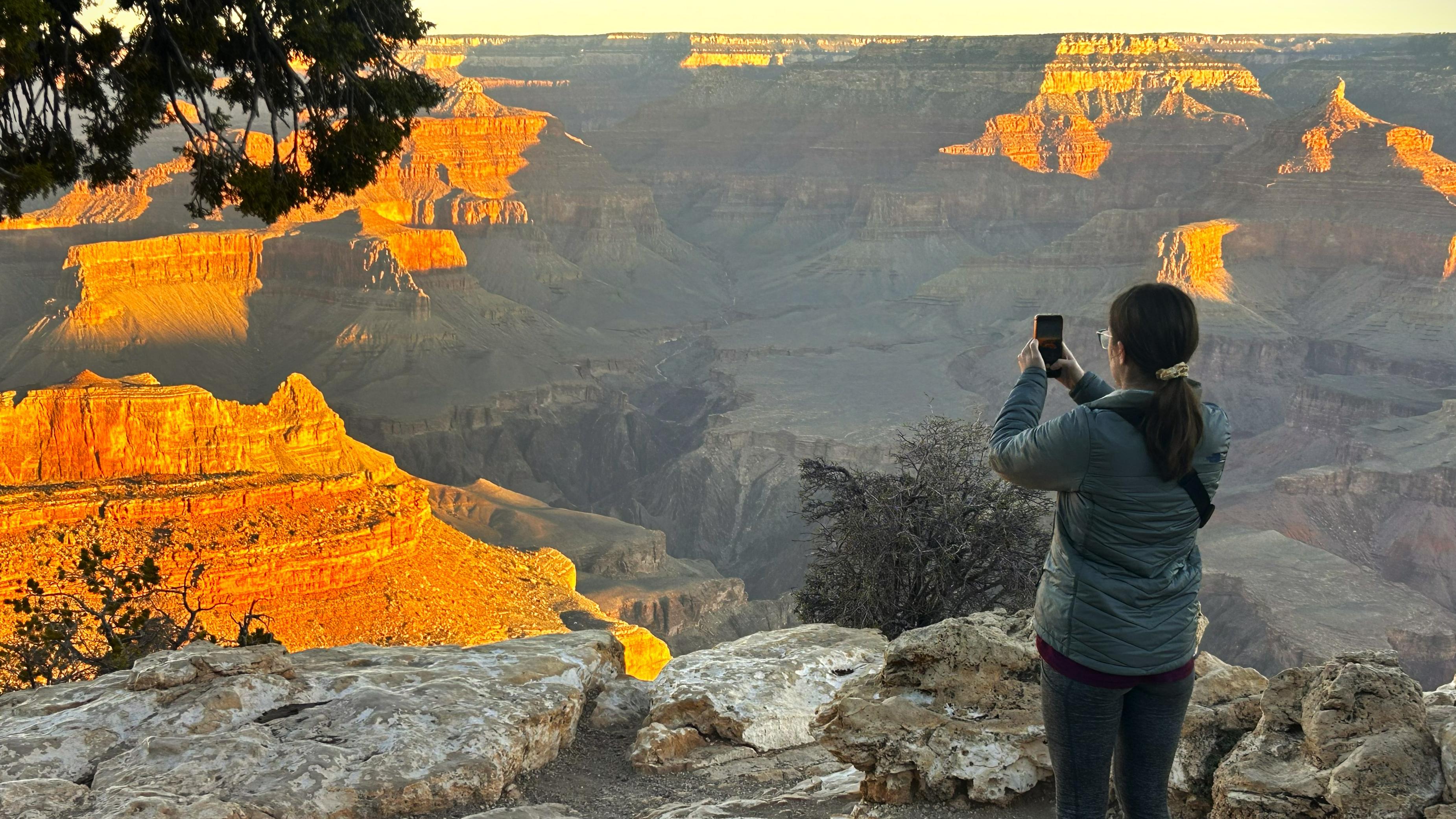 Park Visitors taking photos from standing alongside a guardrail. 