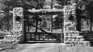 A black and white photo a the pioneer cemetery gate.