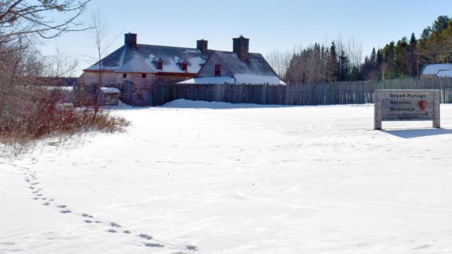 Historic wooden buildings in a snowy landscape.