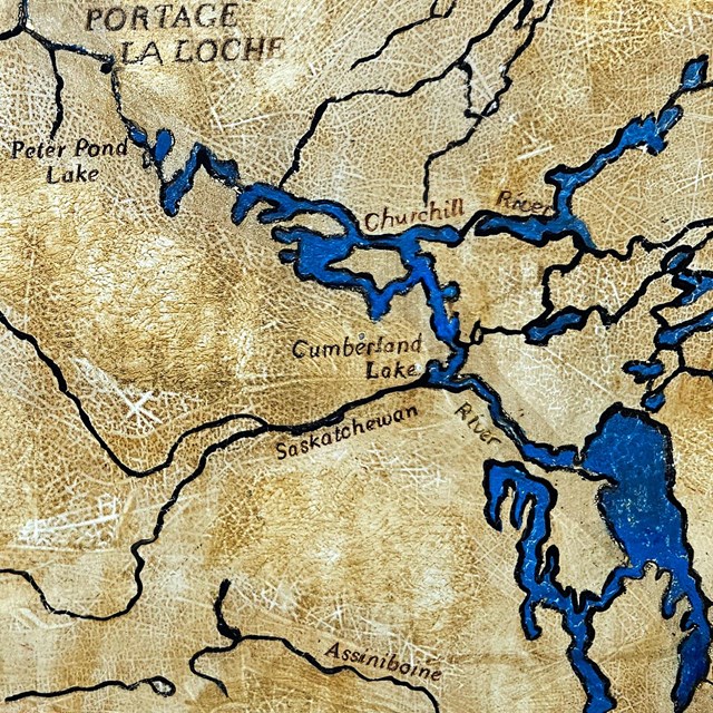 Ochre and blue historic map of central Canada, showing rivers and lakes.