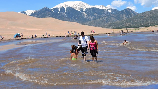Family in Medano Creek at Base of Dunes