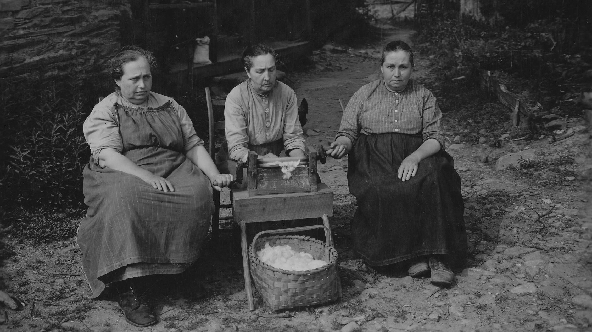 A group of women sit side by side.