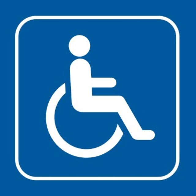 The ADA symbol for accessibility, blue box with white symbol of person in wheelchair.