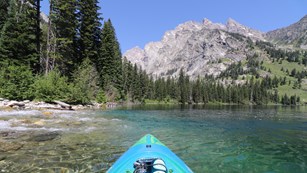 A lake and mountain as seen from the perspective of a kayaker