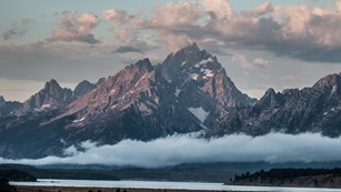 Clouds surround the Teton Range and fog covers the valley