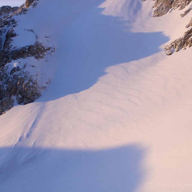 Middle Teton Glacier, viewed from above, its surface covered in winter snow