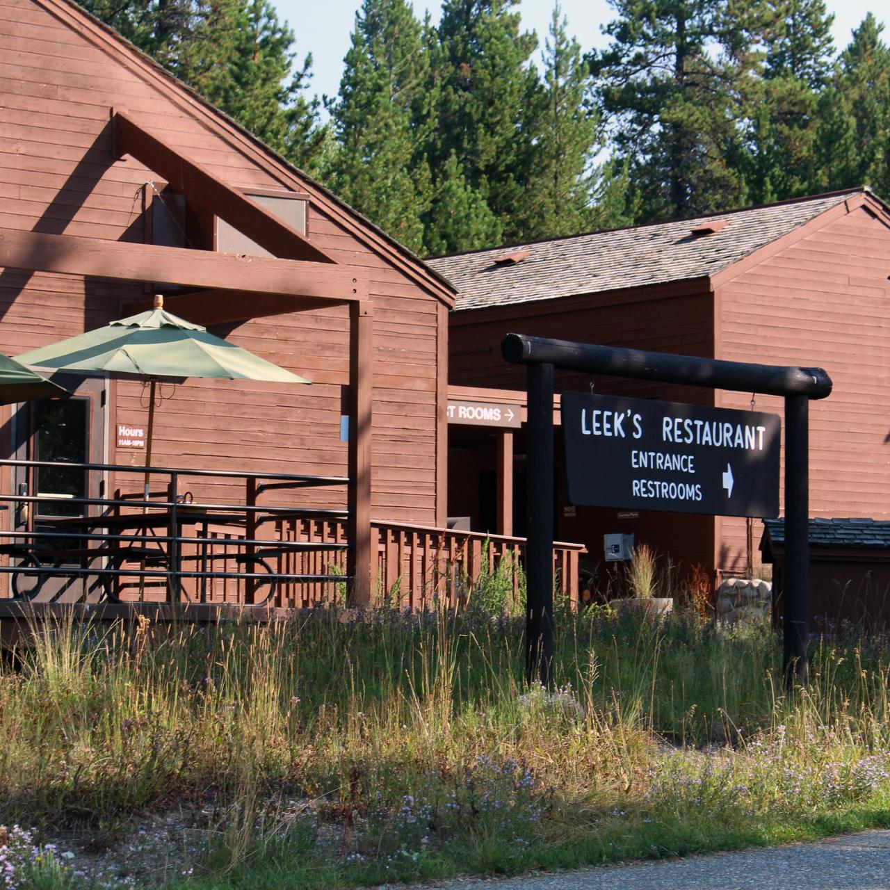 Front of Leeks Pizzeria with brown wood siding.