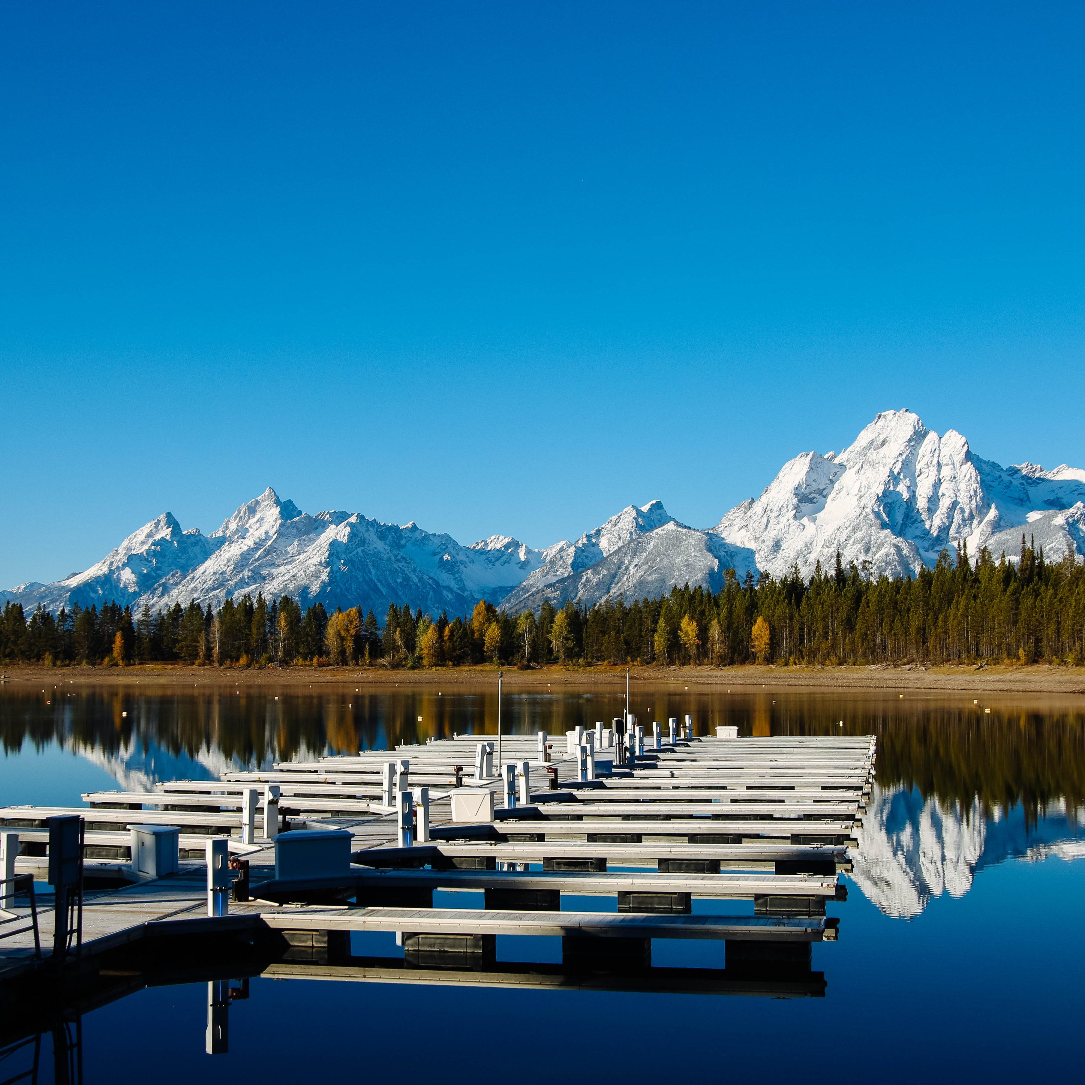 A boat dock with mountains in the background.