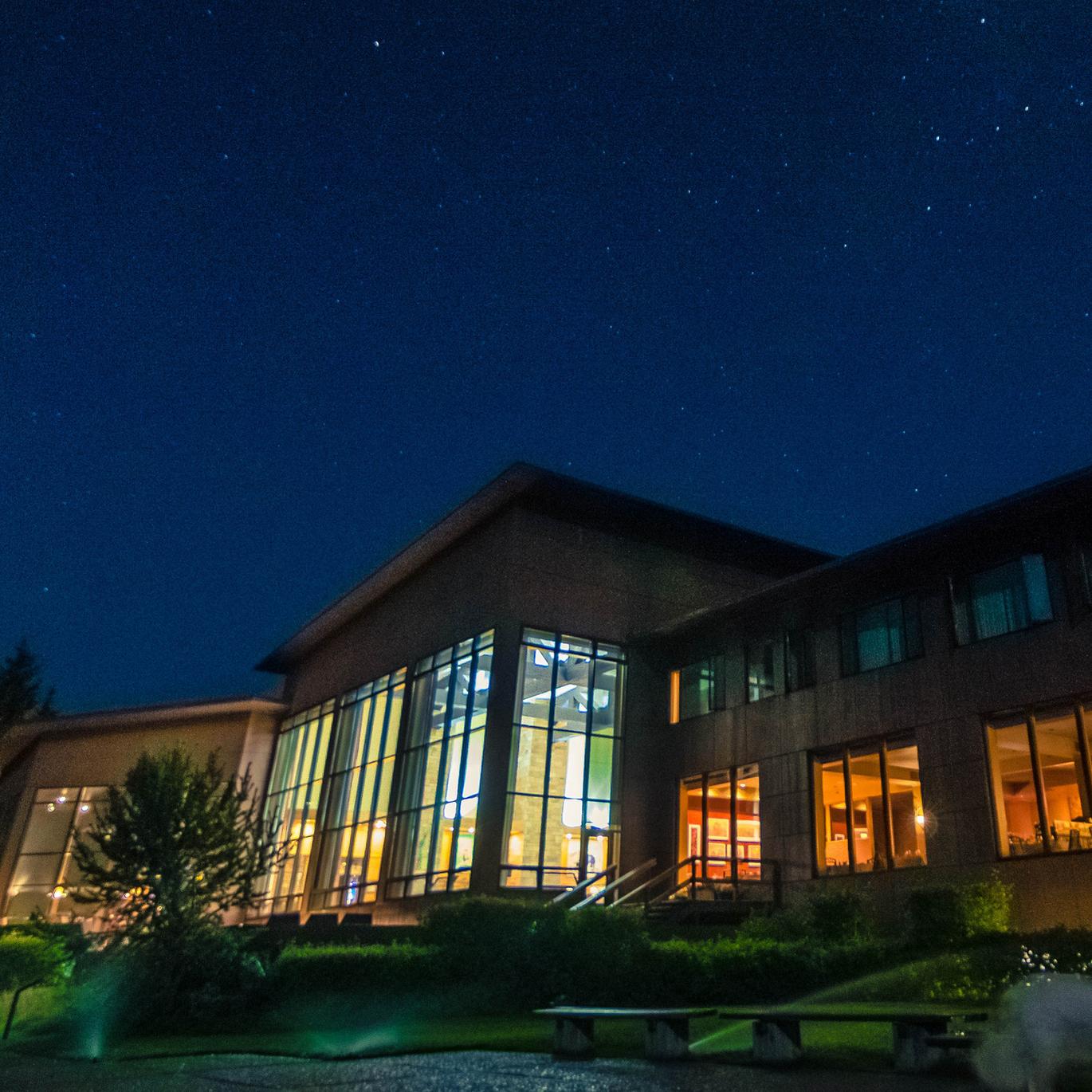 Jackson Lake Lodge at night highlighting the wall of windows.