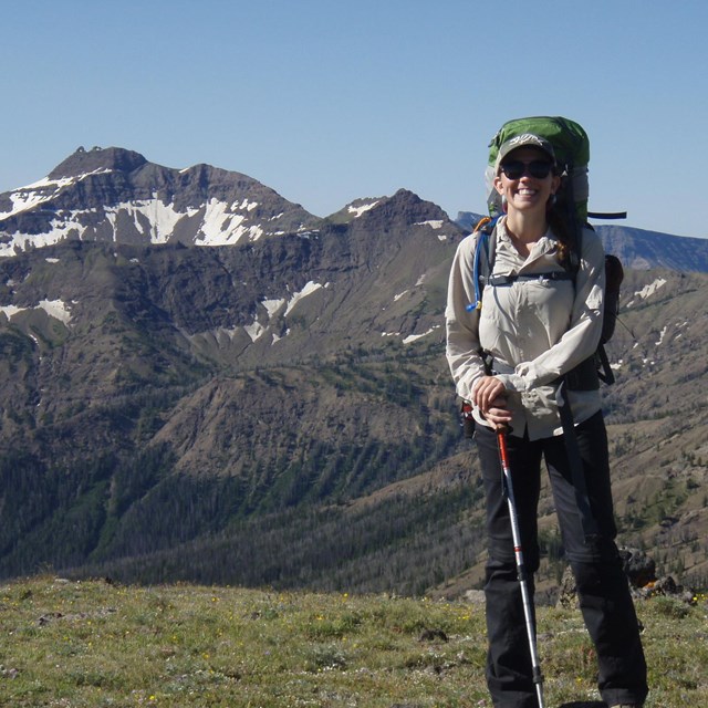 Smiling hiker on an alpine ridge.