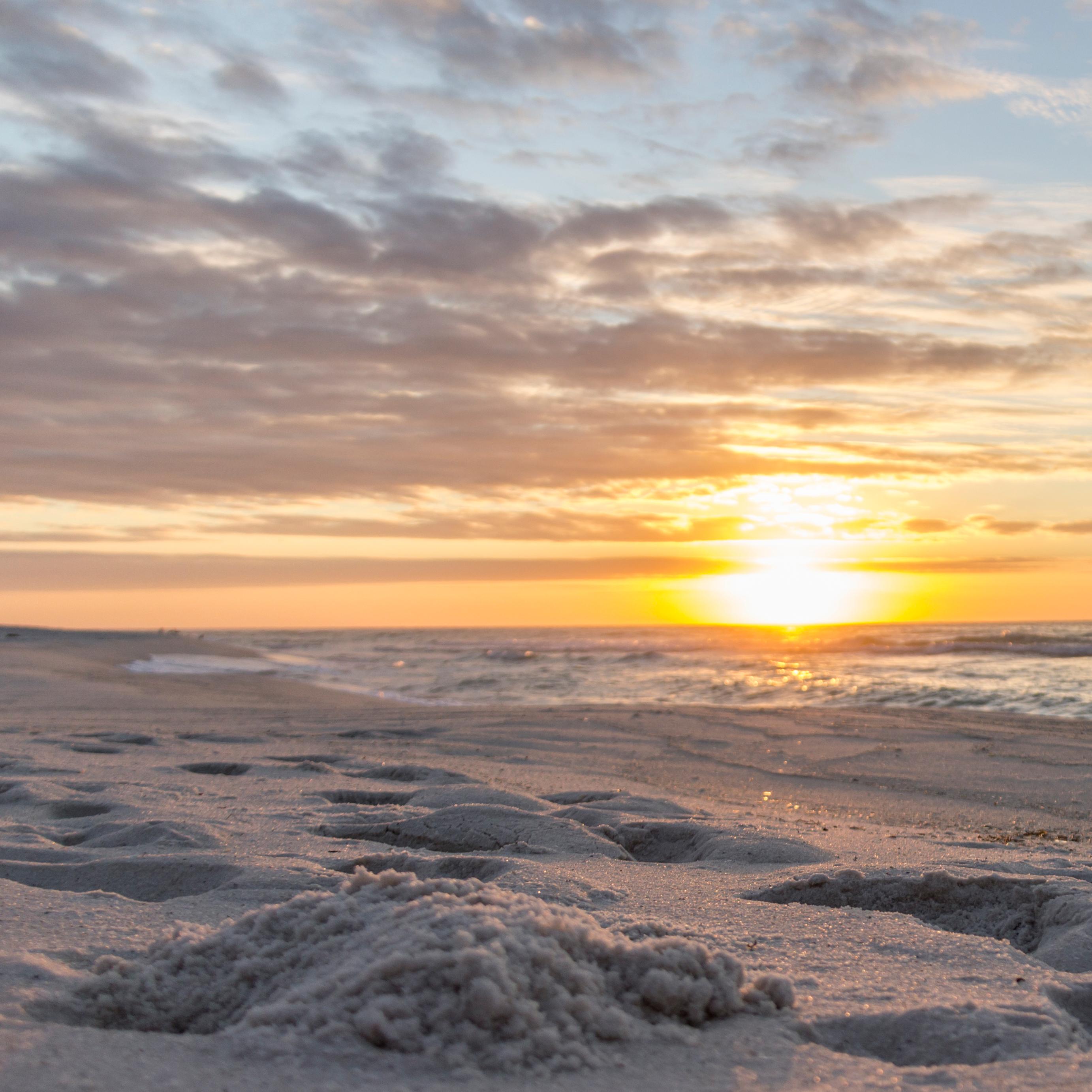 Blue-green waves crash against the white sand beaches of Gulf Islands National Seashore.