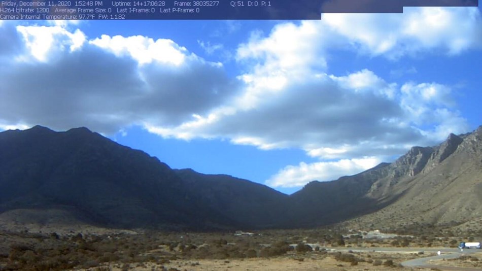 Screenshot of a webcam view into Pine Springs Canyon with clouds in the background