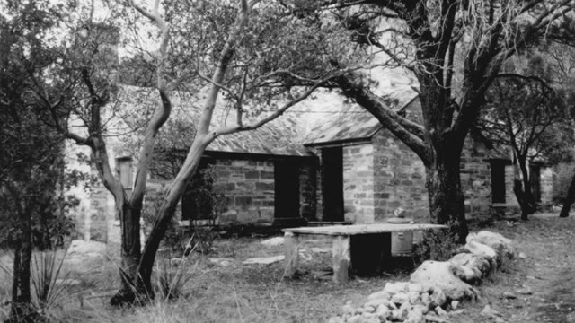 Black and white image of a stone cabin