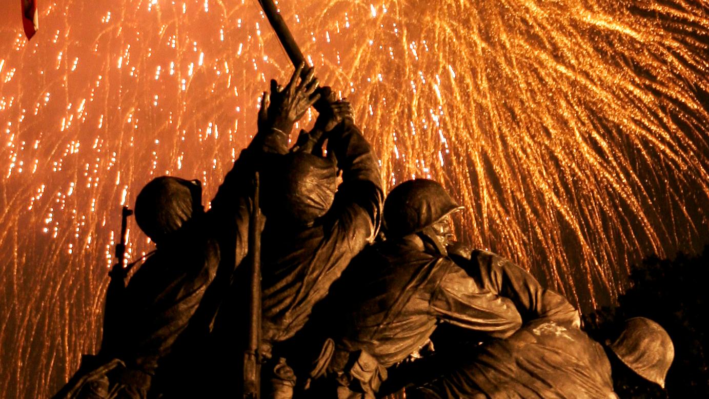 Fireworks illuminate the sky behind the United States Marine Corps War Memorial.