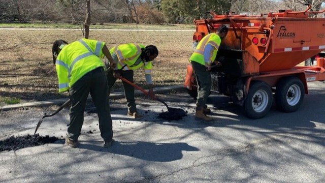 Crews repair a pothole.