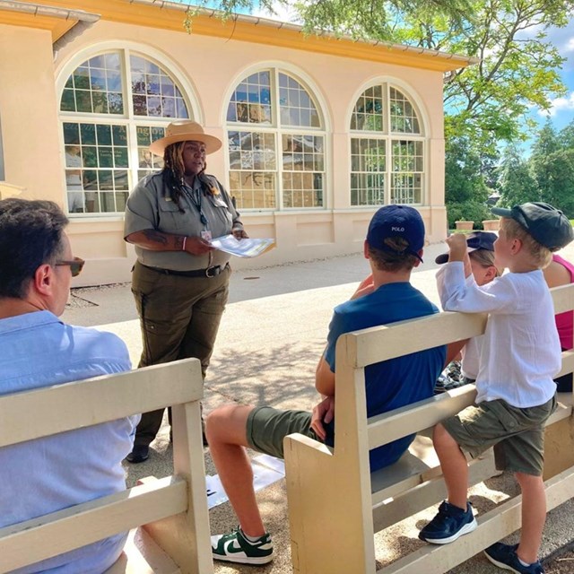 A ranger talking to kids.