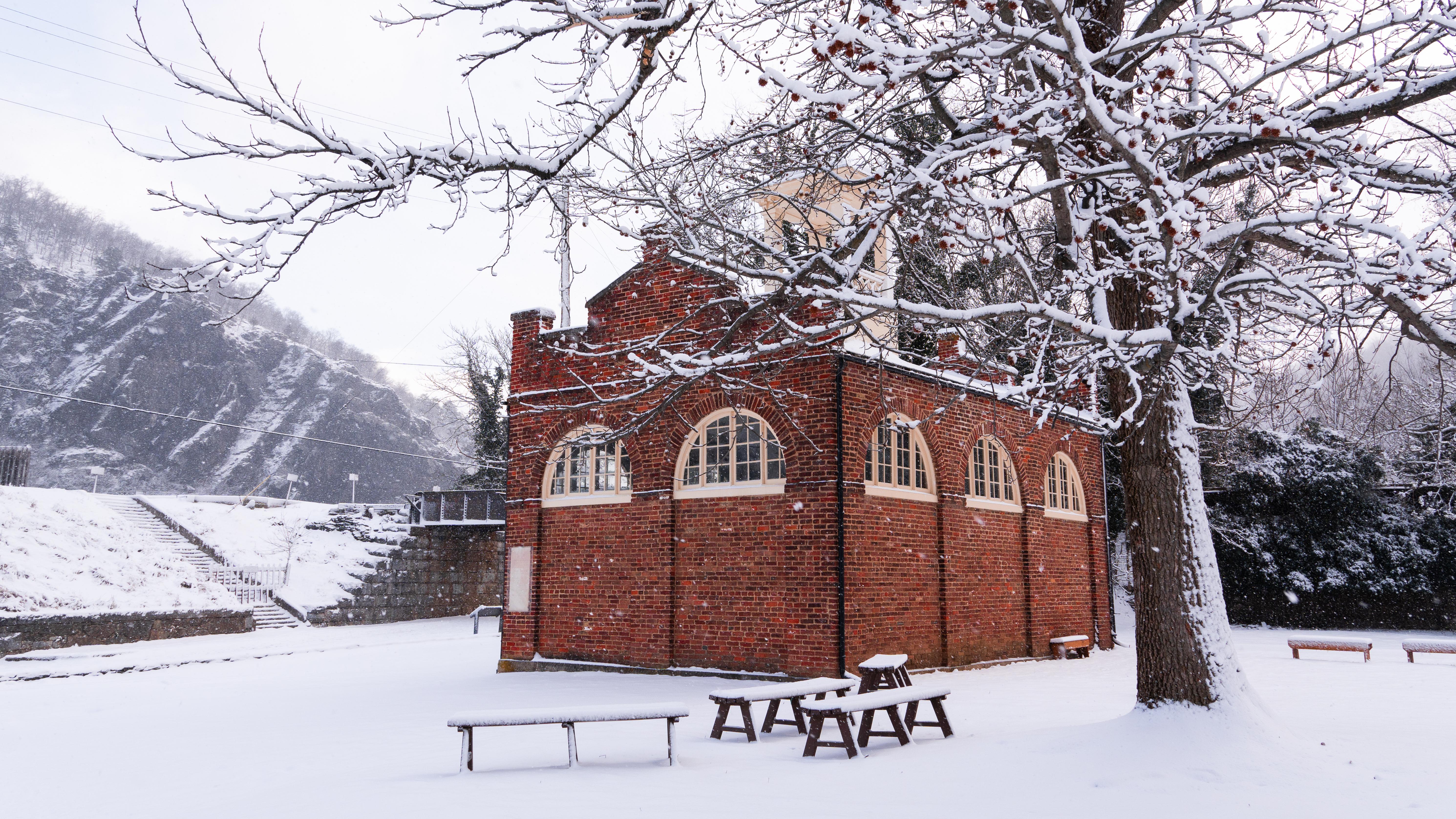 View of John Brown's Fort, a red brick building, surrounded by snow.