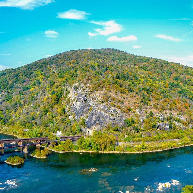 View of Maryland Heights, the town of Harpers Ferry, the railroad tracks, and convergence of rivers.