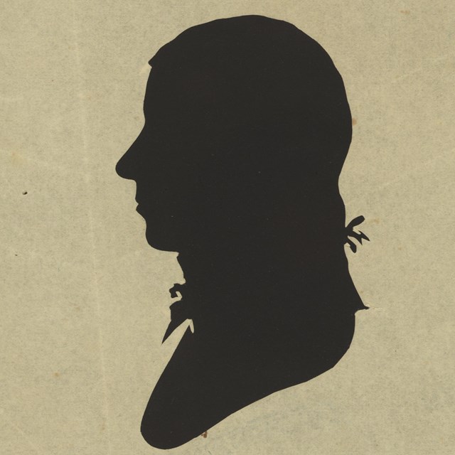 silhouette of a man facing left