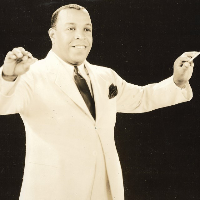 image of Don Redman posed as if conducting his orchestra