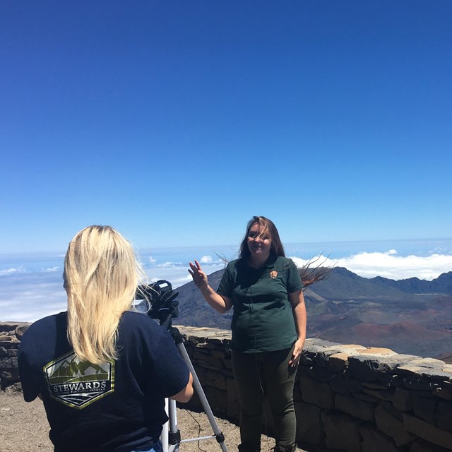 Two park interns film an educational video at the crater rim. 