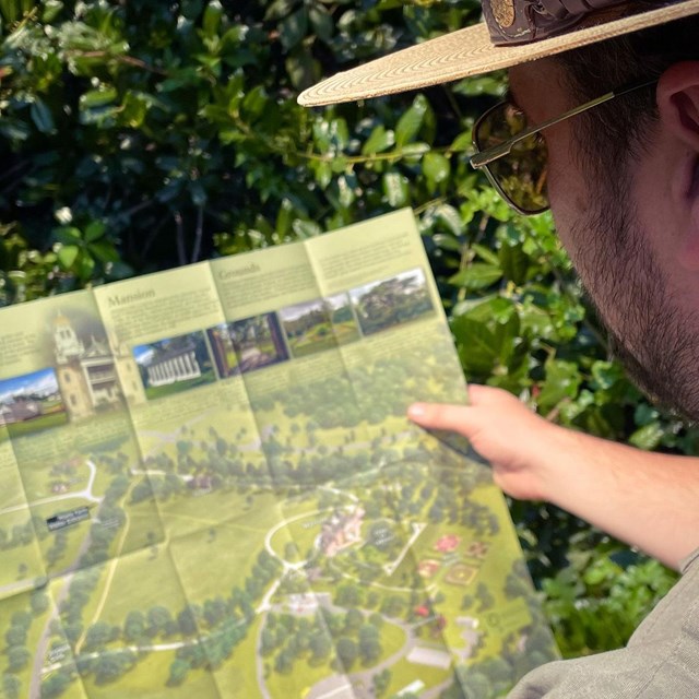 Picture of ranger holding brochure.