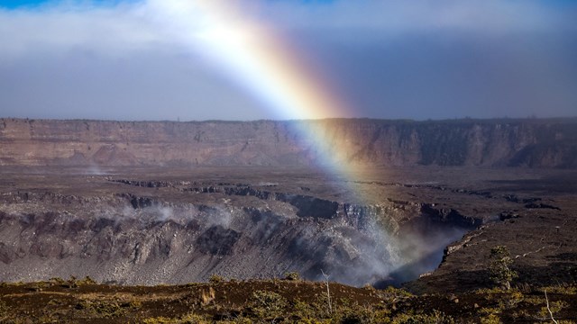 A rainbow above a volcanic caldera.