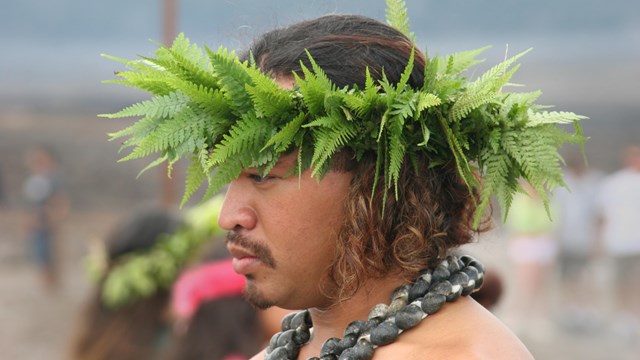 A Native Hawaiian man with a fern lei poʻo