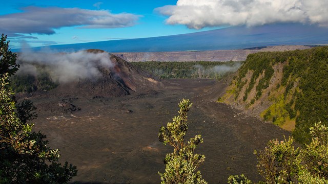 Hikers on the floor of a volcanic crater