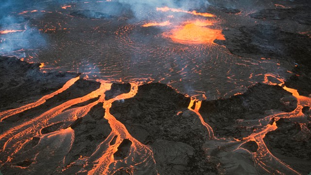 Pond of molten lava and rivulets from above