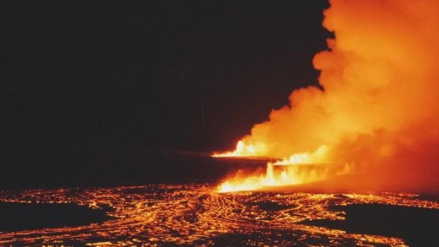 A series of lava fountains at night.