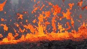 Molten lava spraying out of a fissure