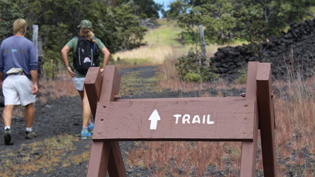 Hikers near a trail sign