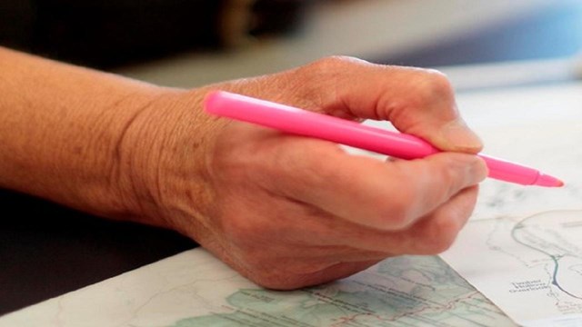 Ranger marking a map with a pen