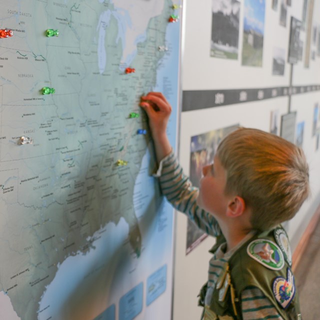 Young boy looking at a map of the United States