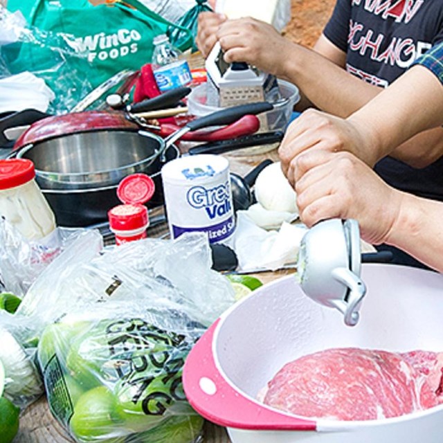 Woman and man preparing meal at picnic table