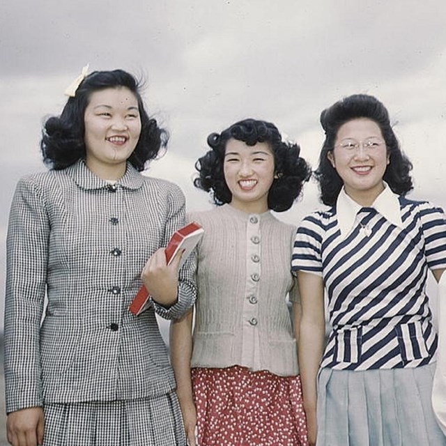 Group of women in mid-20th century clothing. 