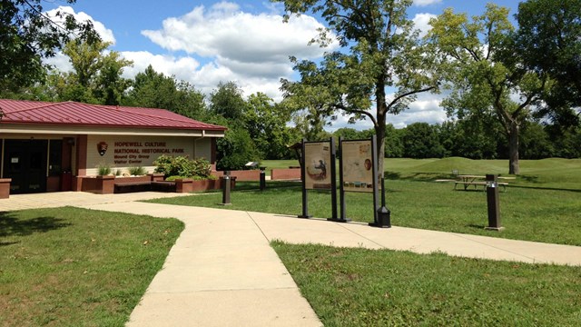 Park visitor center on left with mounds in background