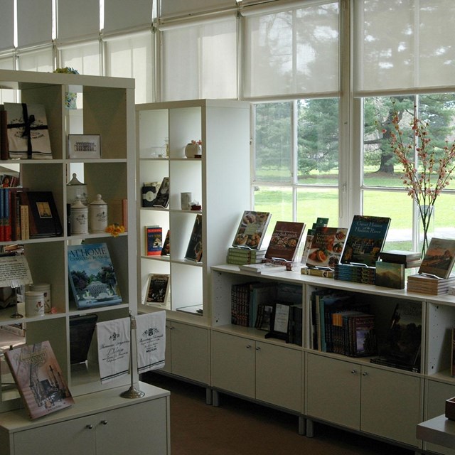 A brightly lit room with shelves of books and merchandise.