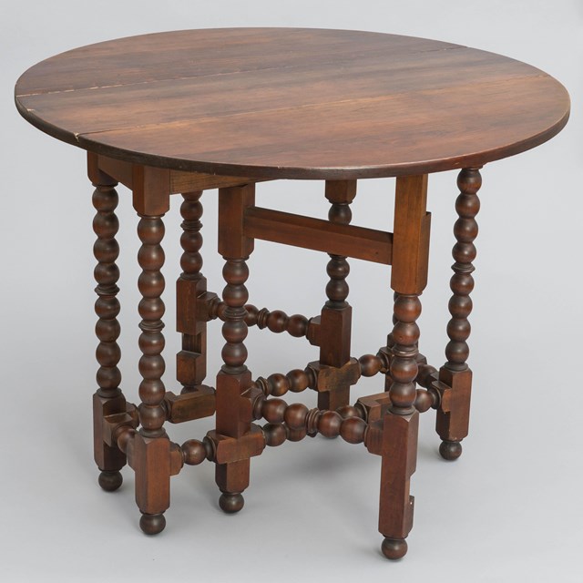 A gateleg table with ball turnings.