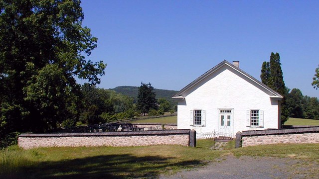 White church surrounded by cemetery.