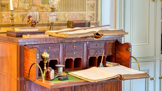 Furnace account book lays open on wood desk.