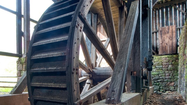 Wooden water wheel inside Cast House.