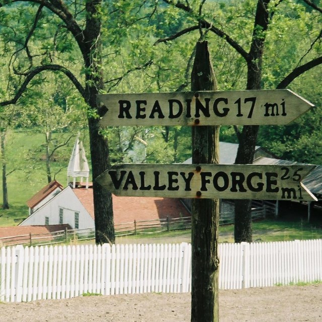 Directional sign showing Hopewell Furnace's historic distance from Reading and Valley Forge, PA. 