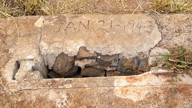 An inscription of Jan. 21, 1943 in concrete in what used to be a guard tower foundation.