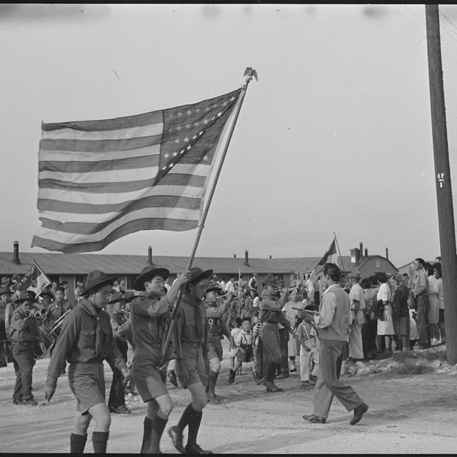 A group of Japanese boys holding an American flag in Amache