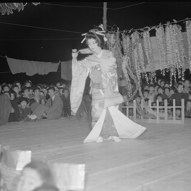 A Japanese folk dancer at an outdoor entertainment